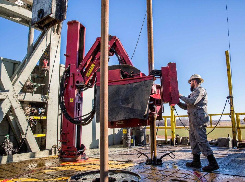 Oilfield engineers monitoring drilling data